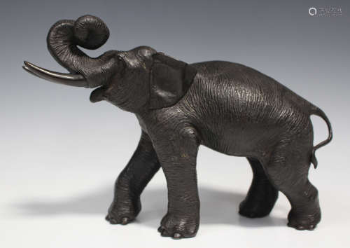 A Japanese cast bronze figure of an elephant, Meiji/Taisho period, finely cast with trunk raised and