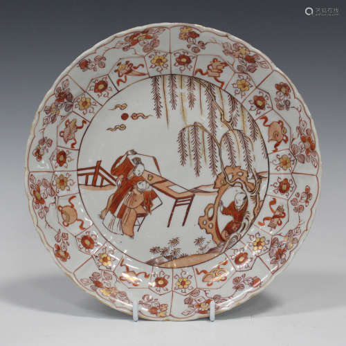A Chinese porcelain circular dish, Kangxi period, painted in iron red and gilt with a central
