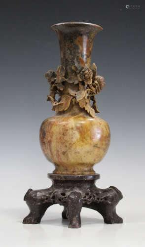 A Chinese brown soapstone vase with integral stand, late Qing dynasty, the flared neck finely carved