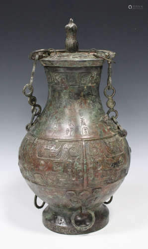 A Chinese archaistic bronze jar and cover, Han style but later, of hu form, the body cast with bands