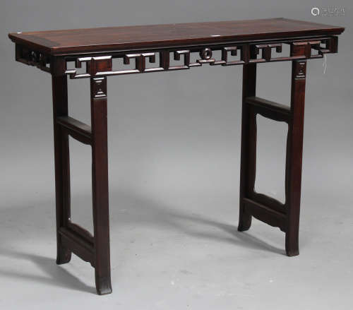 A Chinese hardwood altar table, late Qing dynasty, the rectangular panelled top above a pierced