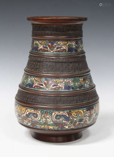 A Chinese brown patinated bronze and champlevé enamel vase, late Qing dynasty, of ribbed hu form,
