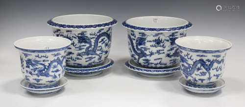 A pair of Chinese blue and white porcelain jardinières and stands, mark of Qianlong but 20th