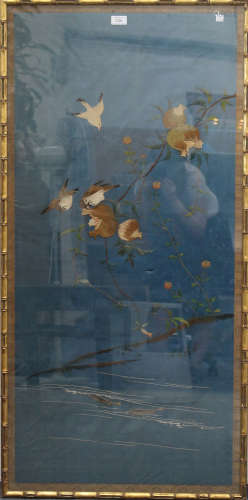 A Chinese silk embroidered panel, late Qing dynasty, finely worked in coloured threads with three