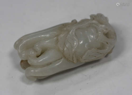 A Chinese carved pale celadon jade pendant, late Qing dynasty, modelled in the form of a Buddha's