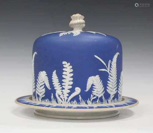 A dark blue dip jasperware cheese dome and stand, late 19th century, typically sprigged in white,