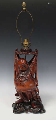 A Chinese carved hardwood Buddha table lamp base, early 20th century, modelled standing holding a