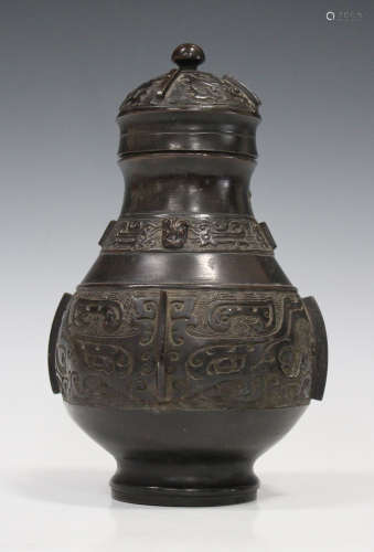 A Chinese archaistic brown patinated bronze wine vessel (you), late Qing dynasty, the baluster