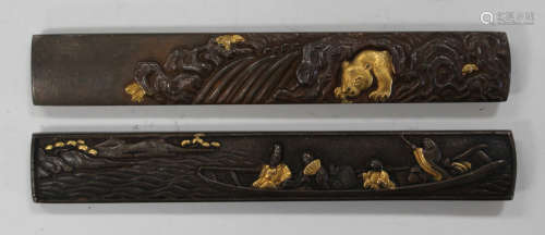 Two Japanese copper kozuka, Meiji period, one handle decorated in relief with figures in a boat, the