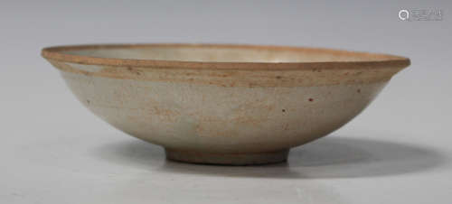 A Chinese provincial pale green glazed earthenware bowl, Ming dynasty, of shallow circular form,