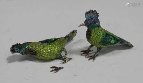 A pair of Chinese enamelled gilt metal figures of exotic birds, 20th century, each decorated with