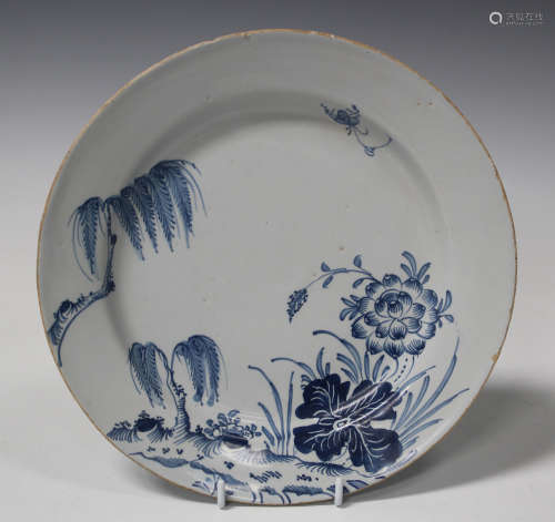 An English delft plate, probably London, mid-18th century, painted in blue with an insect hovering
