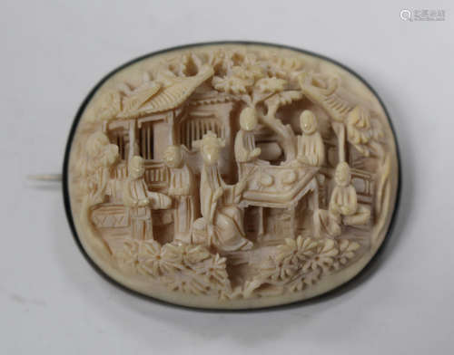 A Chinese Canton export ivory oval plaque, mid/late 19th century, carved in high relief with a