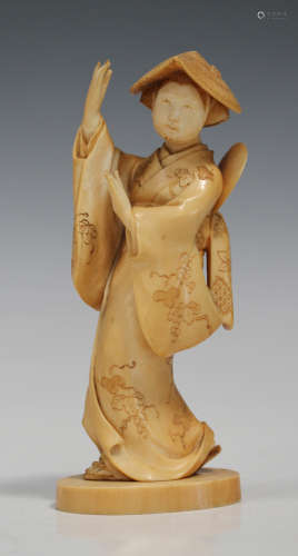 A Japanese carved ivory okimono figure of a female dancer, Meiji period, finely modelled wearing a