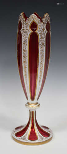 A Bohemian overlay cranberry flashed cut and gilded glass vase, late 19th century, of trumpet form
