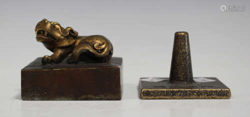 A Chinese parcel gilt bronze seal, the square base surmounted with a seated Buddhistic lion, cast