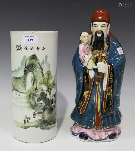 A Chinese porcelain cylindrical vase, 20th century, painted with a landscape beneath black text,