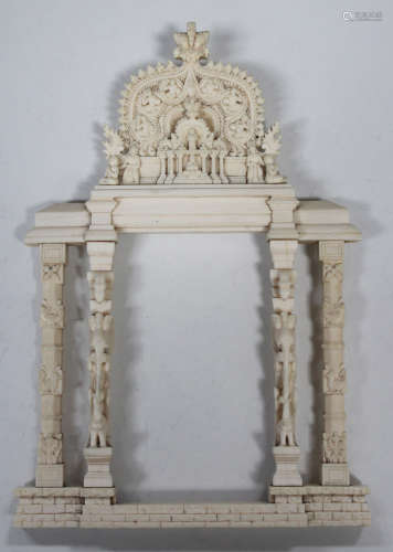 A Ceylonese carved ivory frame, 19th century, formed as two pairs of columns, carved in relief