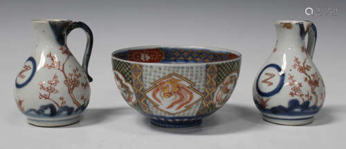 A pair of Japanese Arita Imari porcelain cruet jugs, late 17th century, each body painted and gilt