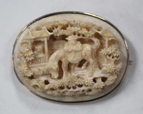 A Chinese Canton export ivory oval plaque, mid-19th century, carved and pierced in relief with a