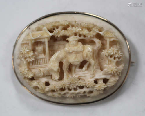 A Chinese Canton export ivory oval plaque, mid-19th century, carved and pierced in relief with a