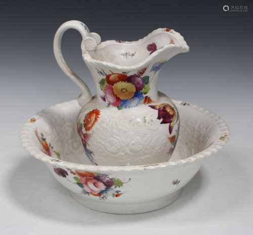 A Staffordshire pottery wash bowl and jug, mid-19th century, moulded and painted with floral sprays,
