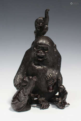 A Japanese dark brown patinated bronze monkey group, Meiji/Taisho period, modelled as a larger