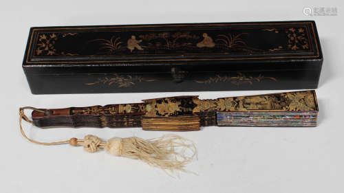 A Chinese Canton export lacquer folding fan, mid-19th century, the guards and fourteen sticks