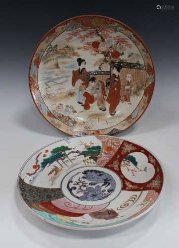 A Japanese Kutani porcelain circular dish, Meiji period, painted with figures in a landscape,