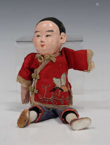 A Chinese papier-mâché and silk doll, early 20th century, wearing an embroidered silk costume,