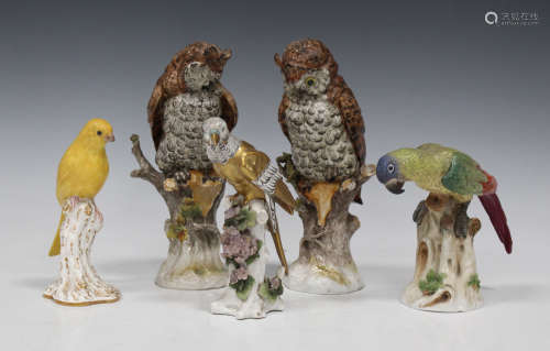 A pair of Capodimonte porcelain owls, 20th century, each modelled on a naturalistic tree base,
