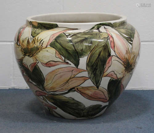 A large Continental pottery jardinière, 20th century, decorated with stems of flowering magnolia,