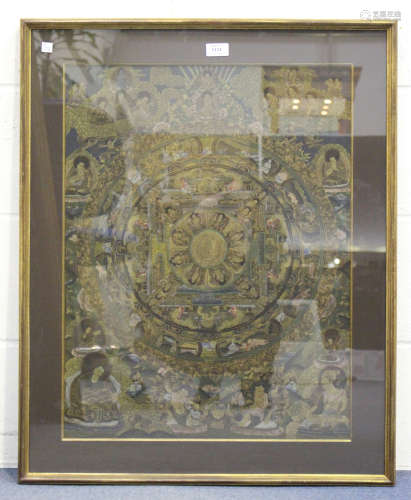 A Tibetan thangka, 20th century, painted and gilt with a wheel shaped design, filled and