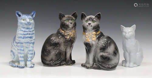 A pair of Staffordshire pottery cats, circa 1900, each with gilt bow collar detail and applied green