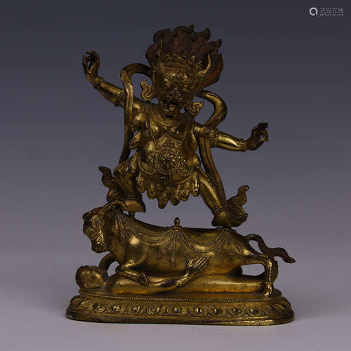 TIBETAN GILT BRONZE STANDING BUDDHA ON CATTLE