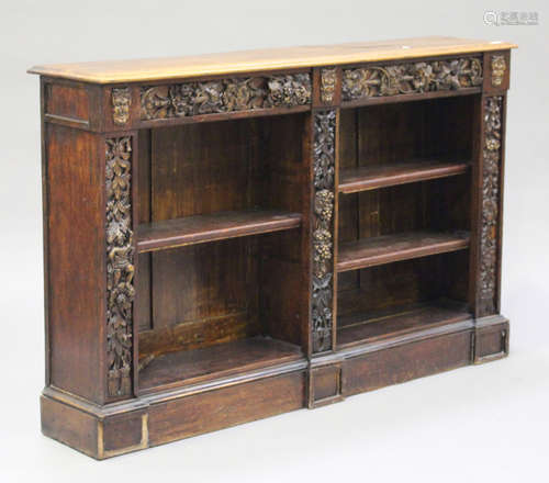 A late Victorian oak open bookcase with relief moulded decoration, on a plinth base, height 101cm,