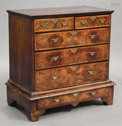 A George I walnut and feather banded chest-on-stand, fitted with two short and three long drawers,