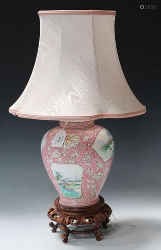 A Chinese style porcelain table lamp, the ovoid body painted with landscape reserves against a