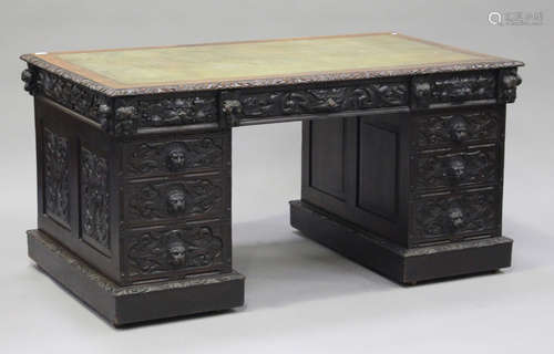 A late Victorian oak twin pedestal desk, the top inset with green leather above and arrangement of