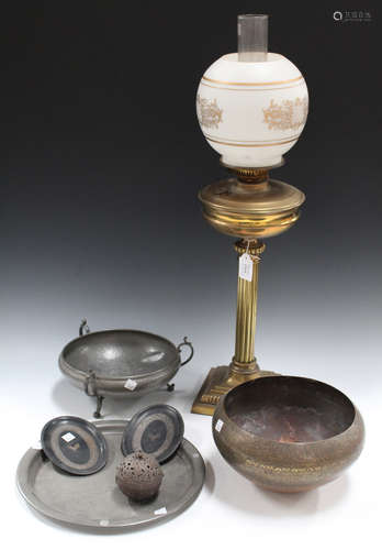 An early 20th century brass table oil lamp, an Eastern engraved brass bowl, a pewter bowl and