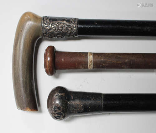 A late 19th century rhino horn handled walking stick with an ebony shaft, length 85cm, another ebony