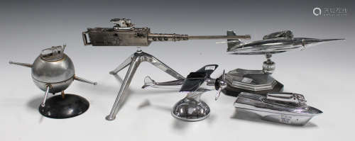 A group of five novelty table lighters, including one in the form of a Browning gun, two aeroplanes,