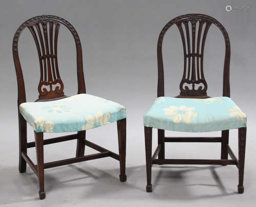 A set of ten George III and later Hepplewhite style mahogany dining chairs with carved and pierced