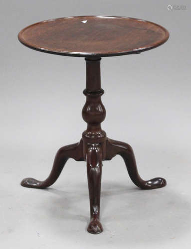 A George III mahogany wine table, the dished circular top with chequer stringing, raised on a turned