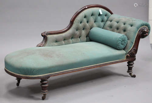 A Victorian mahogany showframe chaise longue with carved lion's mask, upholstered in green