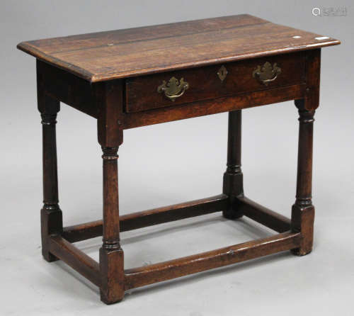 An 18th century oak side table, fitted with a drawer, on turned and block legs united by stretchers,