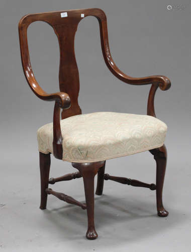 An unusual George III walnut armchair with shaped splat back and downswept armrests, the overstuffed