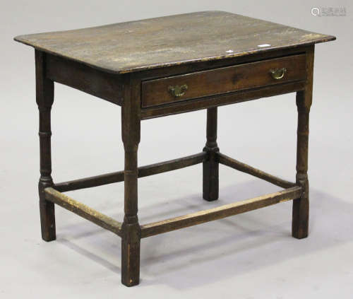 A 17th century oak lowboy, fitted with a single frieze drawer, on turned legs united by block