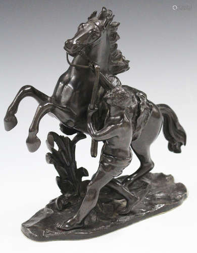 After Guillaume Coustou - a late 19th century brown patinated cast bronze figure group of a Marly