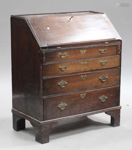 A George III oak bureau, the fall front above four graduated long drawers, on bracket feet, height